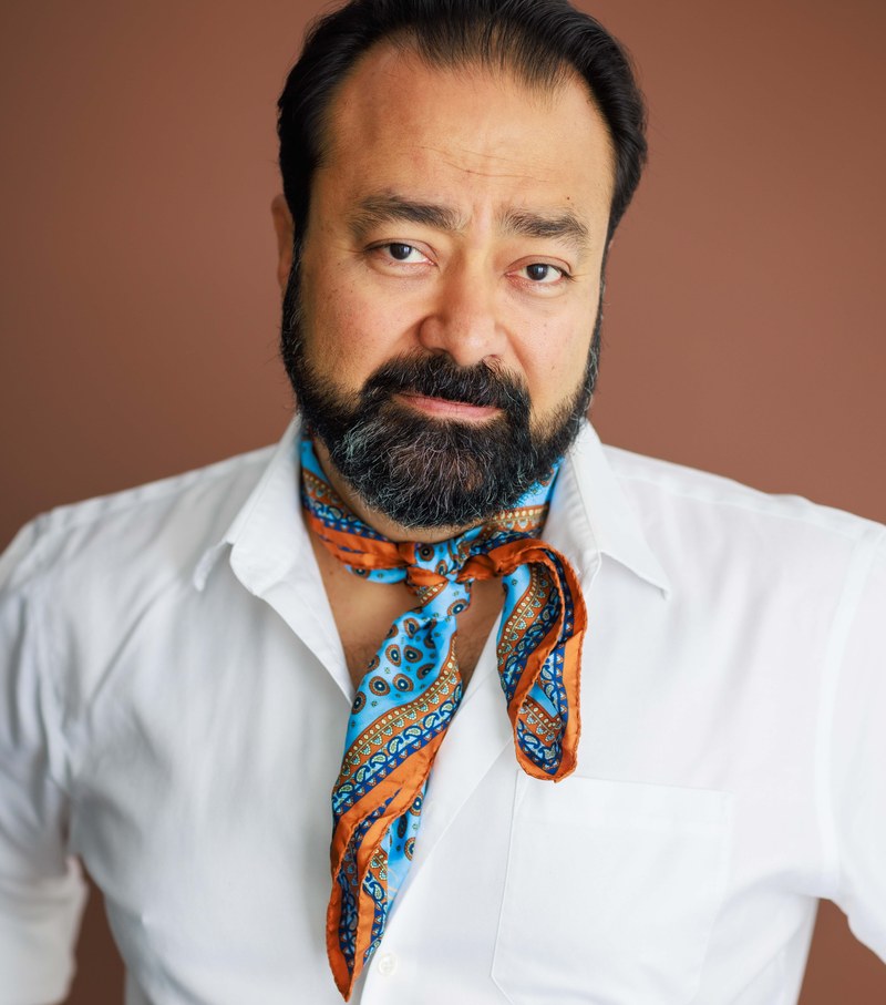 Gautam Kannan, headshot in white shirt and patterned scarf