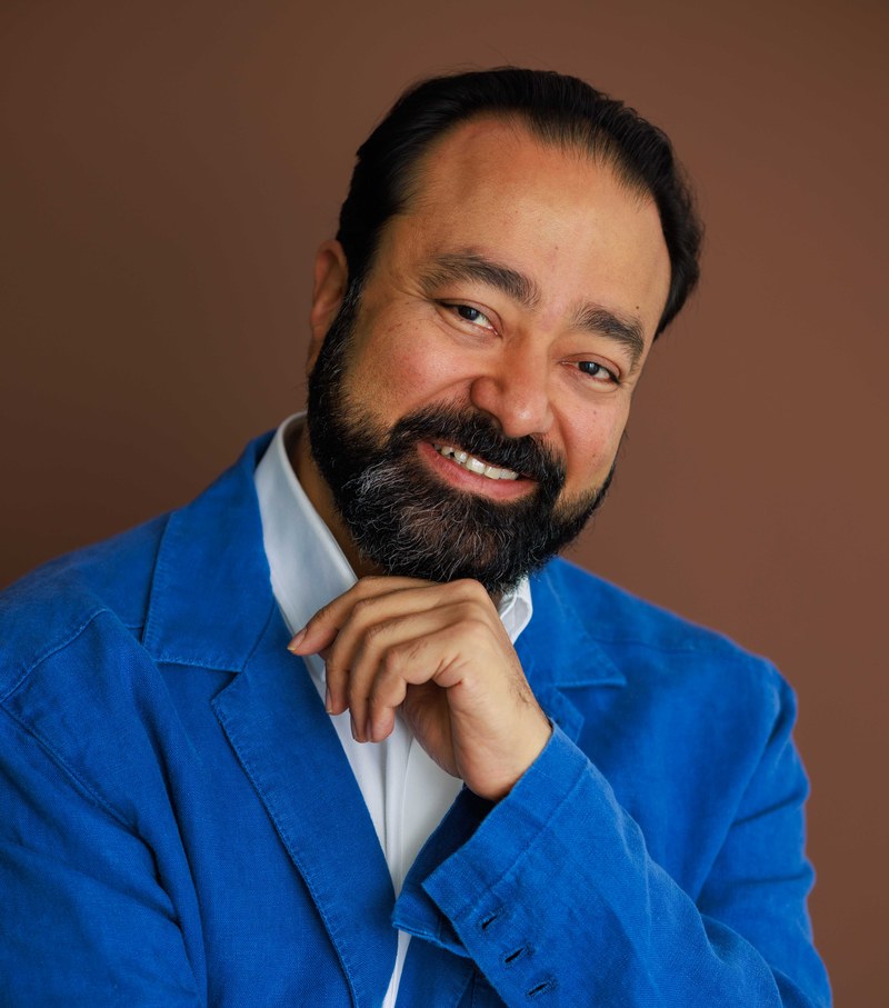 Gautam Kannan, headshot in blue jacket, smiling