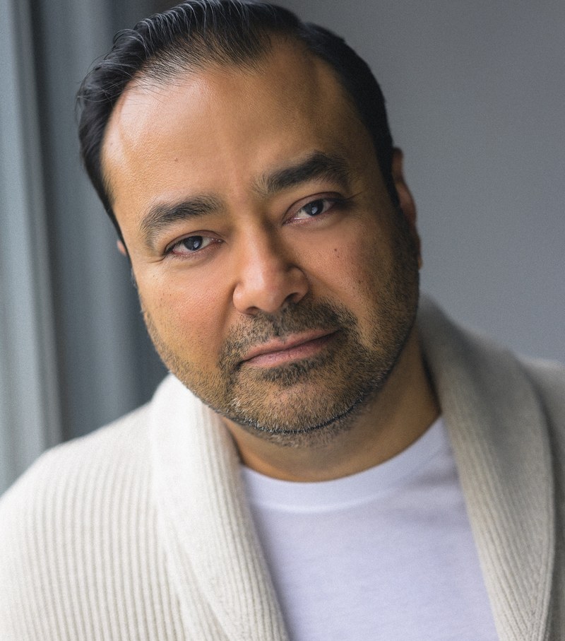 Gautam Kannan, clean-shaven headshot in cream cardigan